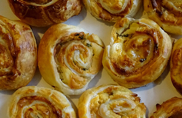 The pinwheels are golden brown and crispy,  placed side-by-side, creating a spiral pattern.