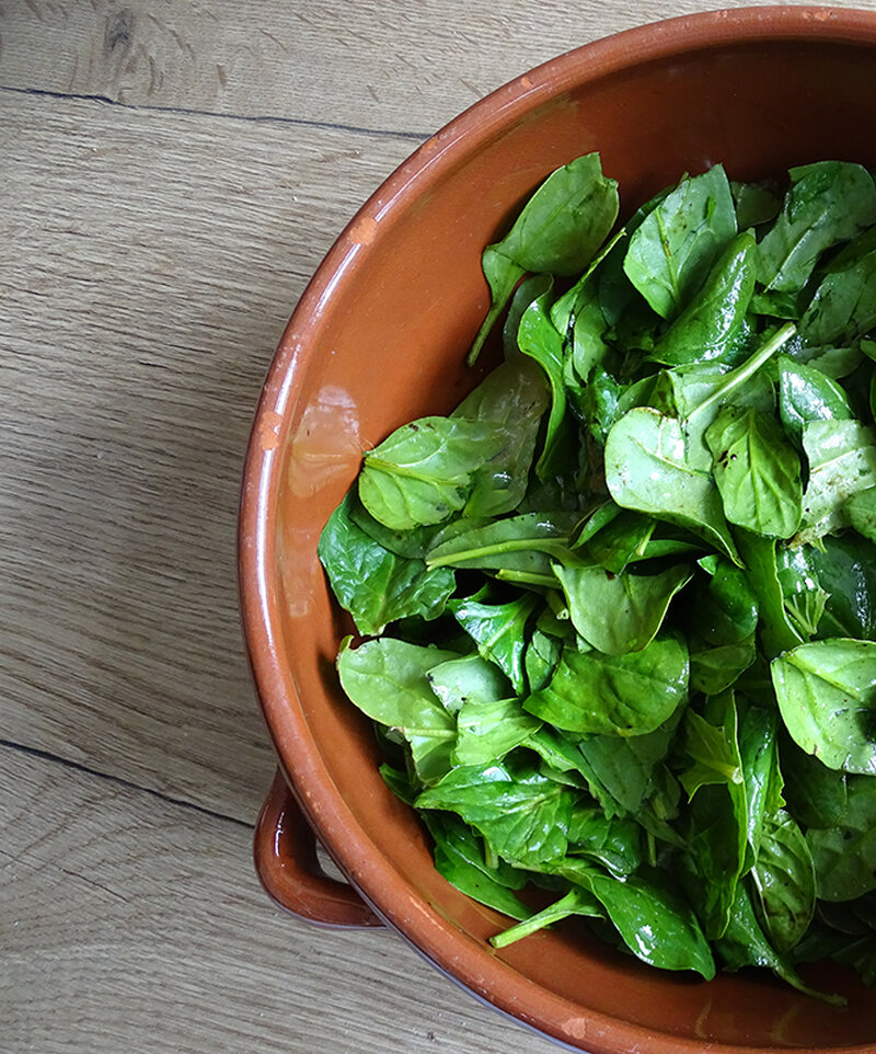 The spinach is dressed and torn.