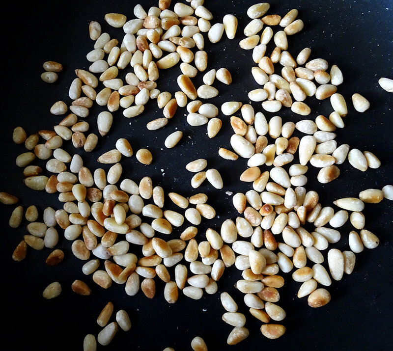 Toasted pinenuts are golden brown