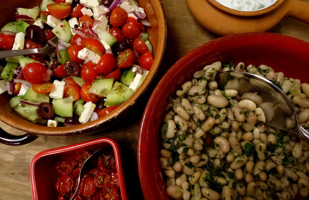 A table laden with a selection of bright fresh vegetarian salads 