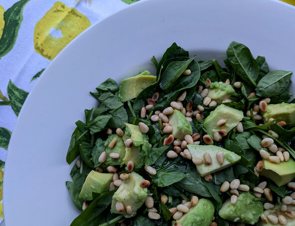 Spinach and avocado with toasted pinenuts