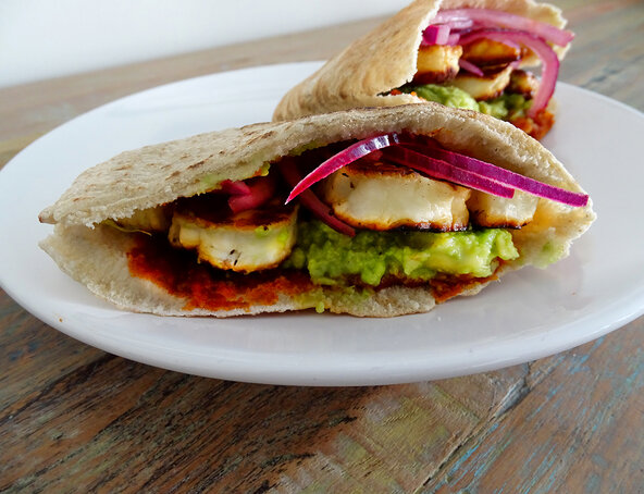 Warm halloumi pitta with harissa, avocado and lime-pickled onions